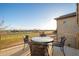 Balcony features a glass-topped patio table with seating and views of the golf course at 14257 W Harvard St, Goodyear, AZ 85395