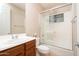 Well-lit bathroom featuring a shower over the tub with glass doors and updated vanity at 14257 W Harvard St, Goodyear, AZ 85395