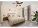 Comfortable bedroom showcasing a neutral color palette, soft carpet, large window, and ceiling fan at 14257 W Harvard St, Goodyear, AZ 85395