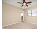 Light-filled carpeted bedroom with a ceiling fan, a window with blinds, and glass paneled doors at 14257 W Harvard St, Goodyear, AZ 85395