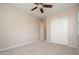 Neutral bedroom featuring a ceiling fan, neutral carpet and closet with sliding doors at 14257 W Harvard St, Goodyear, AZ 85395