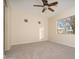 Well-lit bedroom with neutral carpet and walls, large window and a ceiling fan at 14257 W Harvard St, Goodyear, AZ 85395