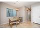 Dining area featuring travertine floors, chandelier, and natural lighting at 14257 W Harvard St, Goodyear, AZ 85395