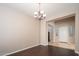 An elegant dining area adjacent to foyer and entryway features hardwood floors at 14257 W Harvard St, Goodyear, AZ 85395