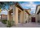 Architectural details highlight the front exterior with stucco columns and brick-paver pathway at 14257 W Harvard St, Goodyear, AZ 85395