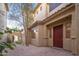 Inviting front entrance with brick pathway, desert landscaping, and a secure red front door at 14257 W Harvard St, Goodyear, AZ 85395