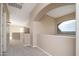 Bright upstairs hallway with large arched windows and neutral walls and carpet at 14257 W Harvard St, Goodyear, AZ 85395