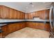 Open kitchen featuring wood cabinetry, granite counters, and tile flooring at 14257 W Harvard St, Goodyear, AZ 85395