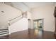 Bright living room with wood floors, staircase, high ceilings and sliding glass door to the patio at 14257 W Harvard St, Goodyear, AZ 85395