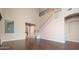 Elegant living room featuring high ceilings, a staircase, and open space, ready for personalization at 14257 W Harvard St, Goodyear, AZ 85395