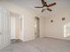 Spacious main bedroom includes a ceiling fan, carpet, and entry to bathroom at 14257 W Harvard St, Goodyear, AZ 85395