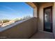 Private patio with neutral textured walls, a doorway, and a beautiful view of the surrounding landscape at 14257 W Harvard St, Goodyear, AZ 85395