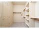 The large walk-in closet has rods and shelving for storage and organization at 14257 W Harvard St, Goodyear, AZ 85395