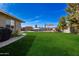 Expansive backyard with a swimming pool and landscaped areas at 1506 E Gemini Dr, Tempe, AZ 85283