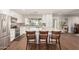 Modern kitchen featuring stainless steel appliances, a center island with bar stools and a view to the backyard at 1506 E Gemini Dr, Tempe, AZ 85283