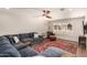 Comfortable living room featuring a large sectional sofa, ceiling fan and a stylish rug for a cozy atmosphere at 1506 E Gemini Dr, Tempe, AZ 85283