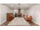 Cozy living room with a brick fireplace, stylish rug, and a piano for added charm at 1506 E Gemini Dr, Tempe, AZ 85283