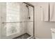 Modern bathroom shower features glass doors, decorative tile, and a sleek showerhead fixture at 1506 E Gemini Dr, Tempe, AZ 85283