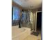 View of bathroom with a tub, glass shower and a stained-glass window at 15266 N 146Th Ln, Surprise, AZ 85379