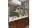 Bathroom featuring a double sink vanity with light wood cabinets at 15266 N 146Th Ln, Surprise, AZ 85379