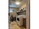 This is a functional laundry room with modern appliances and ample storage space at 15266 N 146Th Ln, Surprise, AZ 85379