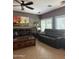 Inviting living room featuring two sofas, a ceiling fan, and stylish desert-themed decor at 15266 N 146Th Ln, Surprise, AZ 85379