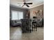 Cozy living room featuring a neutral color palette, a ceiling fan and tiled flooring at 15266 N 146Th Ln, Surprise, AZ 85379