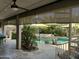 Covered patio that overlooks the pool, spa and lush landscaping at 15266 N 146Th Ln, Surprise, AZ 85379