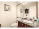 Charming powder room with granite countertop and decorative mirror at 15618 N 12Th Ave, Phoenix, AZ 85023