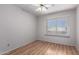 Simple bedroom with hardwood floors and a bright window offers a clean and comfortable space for relaxation at 15618 N 12Th Ave, Phoenix, AZ 85023