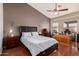 Relaxing bedroom with dark wood floors, a ceiling fan, and a dedicated desk area at 15618 N 12Th Ave, Phoenix, AZ 85023