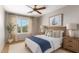 Elegant bedroom with a large window, neutral tones, and stylish decor offers a serene and inviting retreat at 15618 N 12Th Ave, Phoenix, AZ 85023