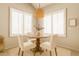 Charming dining nook with plantation shutters, tile floors, and stylish chandelier at 15618 N 12Th Ave, Phoenix, AZ 85023