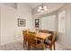 Dining room featuring tile floors, a natural wood table with chairs, and neutral-colored walls at 15618 N 12Th Ave, Phoenix, AZ 85023