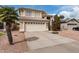 Two-story home featuring a neutral color scheme, two-car garage, tile roof, and desert landscaping at 15618 N 12Th Ave, Phoenix, AZ 85023