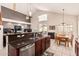 Open kitchen with stainless appliances, granite countertops, and seamless flow to the dining area at 15618 N 12Th Ave, Phoenix, AZ 85023