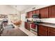 Galley kitchen features stainless steel appliances, granite countertops, and an adjacent dining area at 15618 N 12Th Ave, Phoenix, AZ 85023