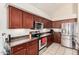 Well-equipped kitchen featuring dark wood cabinetry and stainless steel appliances at 15618 N 12Th Ave, Phoenix, AZ 85023