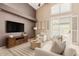Comfortable living room with neutral tones, high ceiling, ceiling fan and a sliding door that leads to the pool at 15618 N 12Th Ave, Phoenix, AZ 85023