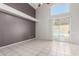 Large living area with a ceiling fan, smooth tile floors, and a sliding door that leads to the pool at 15618 N 12Th Ave, Phoenix, AZ 85023
