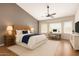 Relaxing main bedroom with a large bed, stylish desk, and plenty of natural light from large windows at 15618 N 12Th Ave, Phoenix, AZ 85023