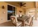 Outdoor patio dining area including ceiling fan, dining table and six chairs, with slider access to the house at 15618 N 12Th Ave, Phoenix, AZ 85023