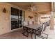 Covered patio with a ceiling fan, dining table, and sliding door to the house at 15618 N 12Th Ave, Phoenix, AZ 85023