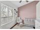 Cozy Bedroom featuring a white crib, rocking chair, and plush area rug at 1600 N Saba St # 224, Chandler, AZ 85225