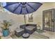 Inviting patio area with a cozy seating arrangement and an umbrella at 1600 N Saba St # 224, Chandler, AZ 85225