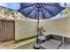 Comfortable patio area with outdoor seating under a blue umbrella at 1600 N Saba St # 224, Chandler, AZ 85225