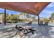 Outdoor seating area with picnic table near pool and lounge chairs under shade structure at 1600 N Saba St # 224, Chandler, AZ 85225