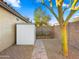 Low-maintenance backyard with desert landscaping, garden beds, and a storage shed at 16207 W Moreland St, Goodyear, AZ 85338