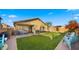 Backyard with a lush lawn, patio seating, and a barbecue grill at 16207 W Moreland St, Goodyear, AZ 85338