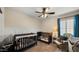 Bedroom featuring neutral color palette and two wooden cribs at 16207 W Moreland St, Goodyear, AZ 85338